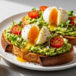 Best avocado toast on sourdough with soft boiled egg flaky salt cherry tomatoes and microgreens